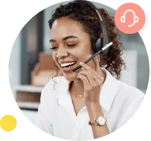 A woman in a white shirt smiles and holds her right hand to the microphone on her hands-free headset.