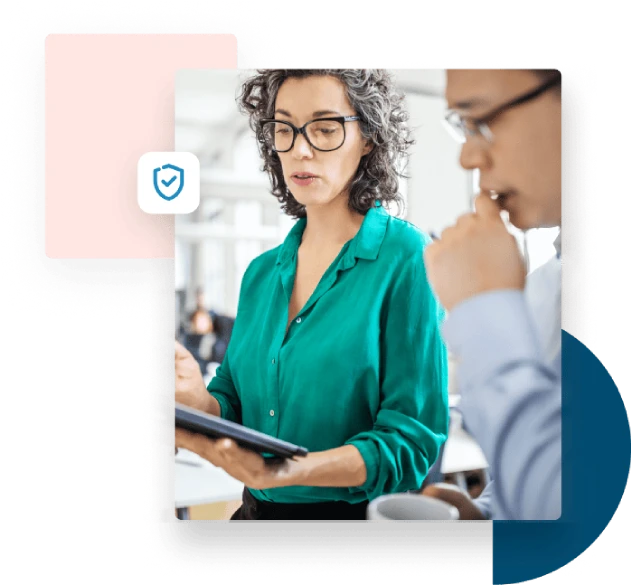 Woman in green blouse shows a tablet to her business partner to discuss security