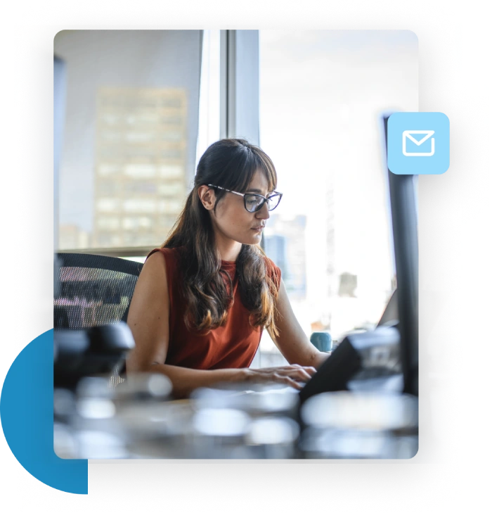 Woman in an office typing at her desk