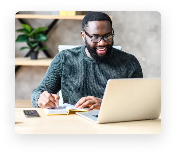 Man smiling as he uses the ZeroBounce email finder to connect with new people in his industry