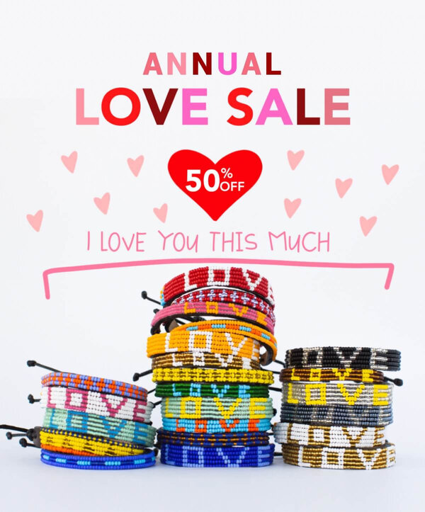 Email advertising a 50% off sale shows love wrist bands and a red heart.