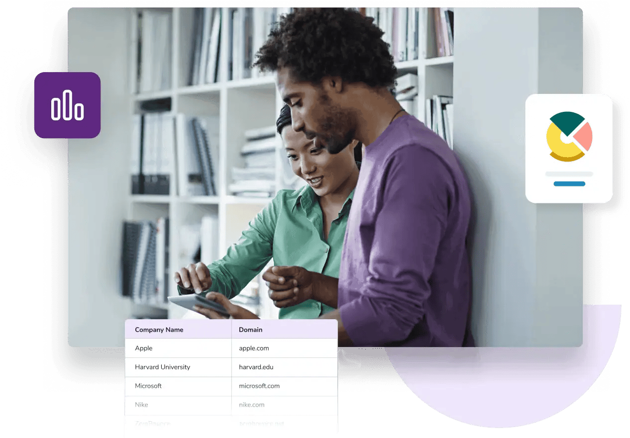 Man and woman standing in front of a bookcase and looking at a tablet with a list of company names and email domains