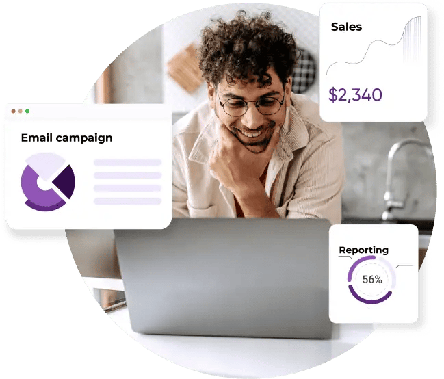 A man smiling while working on his laptop with charts and graphs showing his email campaign being successful increasing his sales.