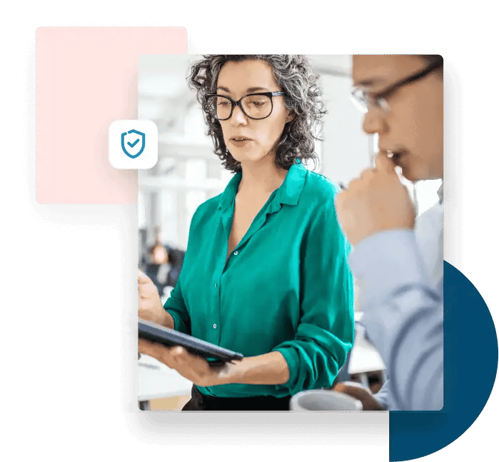 Woman with glasses presents information from her tablet to her male coworker