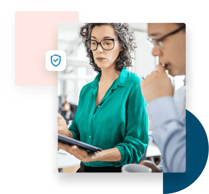 Woman in green blouse shows a tablet to her business partner to discuss security