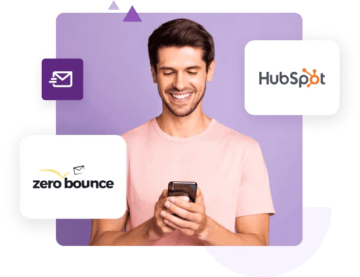 A man in a pink t-shirt smiles at his phone next to the ZeroBounce and HubSpot logos.