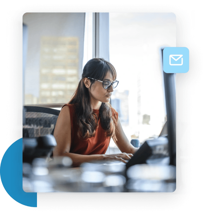 Woman in an office typing at her desk