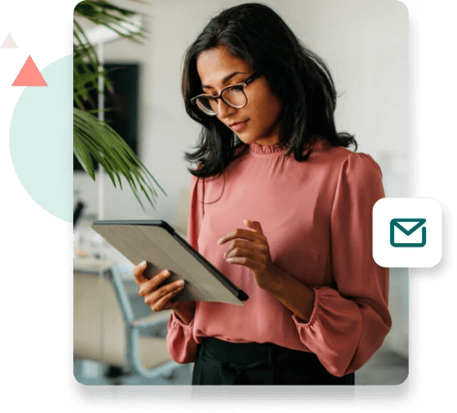 Standing woman reviewing work on her tablet