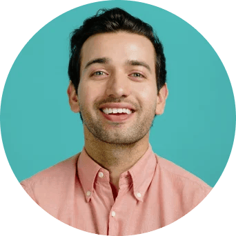 Man in pink shirt smiling at the camera