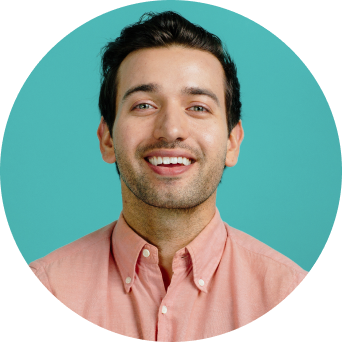 Man in pink shirt smiling at the camera