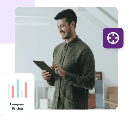 A man in a green shirt and jeans works on his tablet to compare pricing and features.