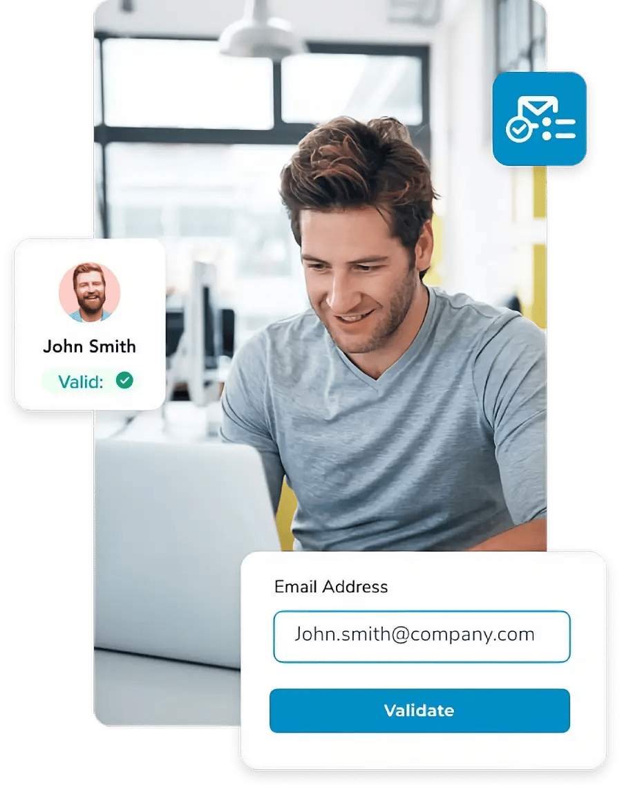 Man smiling looking down at his computer, surrounded by a valid email check for john.smith@company.com