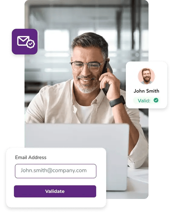 Man talking on his phone while scrubbing his email list on his laptop