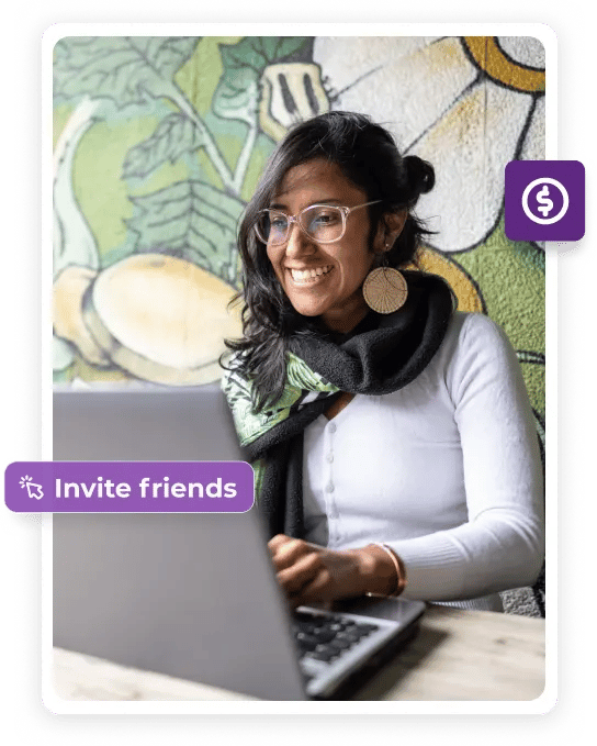 A smiling woman working on her laptop.