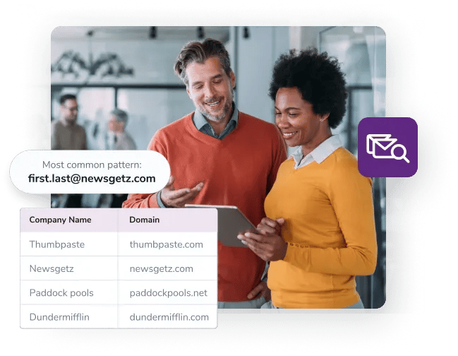 Two standing business partners look at their new list of leads from their bulk email search