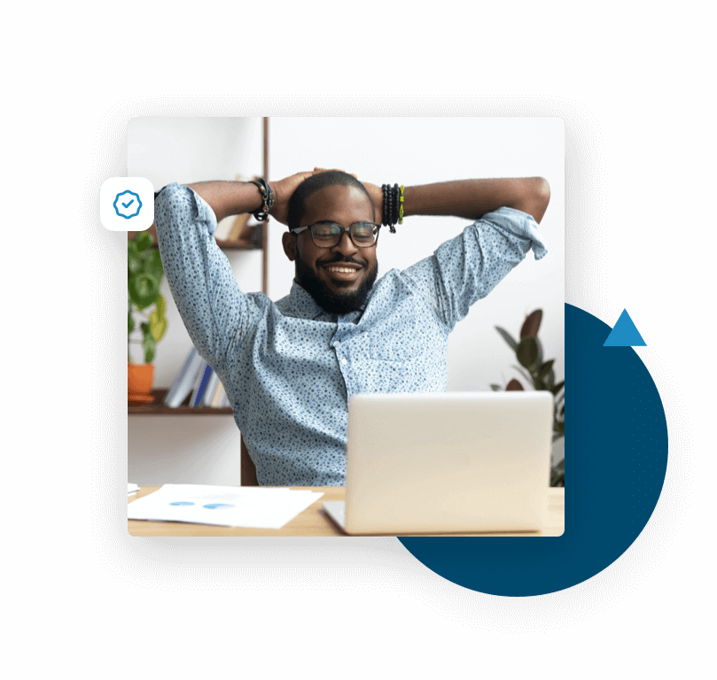 Man sitting at his desk looking at his laptop happy to see his email campaigns are reaching his customers' inboxes, because of the email verification he did with ZeroBounce