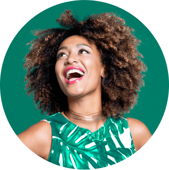 Woman in green looking up to her right and smiling at an email icon