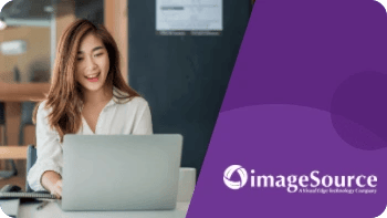 A woman from Image Source checks her laptop to see her reduced bounce rate from her case study.
