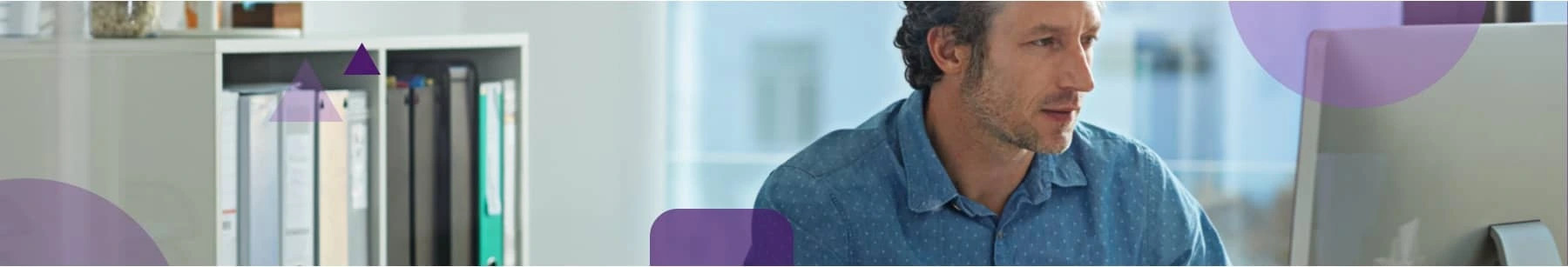 Man sitting at his desk checking his email lists and using ZeroBounce