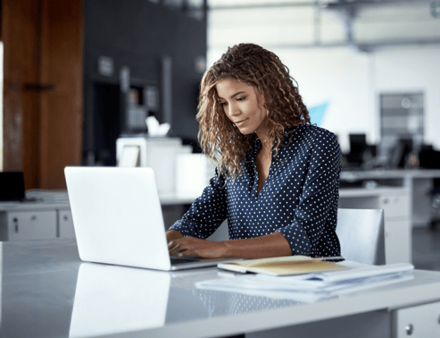 Woman working on her laptop learns about email verification and deliverability