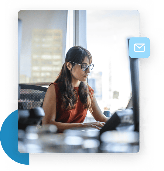 Woman in an office typing at her desk