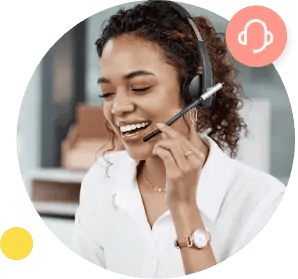 A woman in a white shirt smiles and holds her right hand to the microphone on her hands-free headset.
