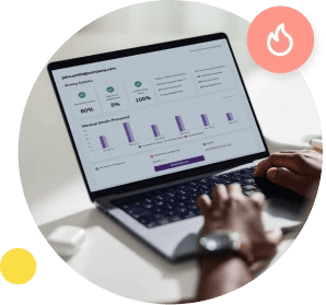 An over the shoulder shot of hands typing on a laptop that shows the email warmup dashboard on screen.