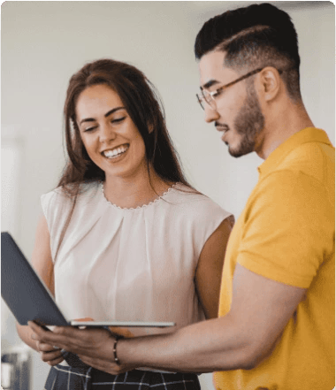 A bearded man in a blue shirt looks directly at the camera.