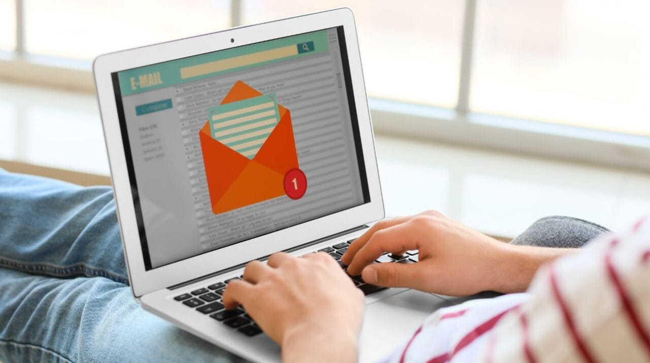 person's hands resting on laptop illustrating the latest ZeroBounce survey that shows most consumers check email daily