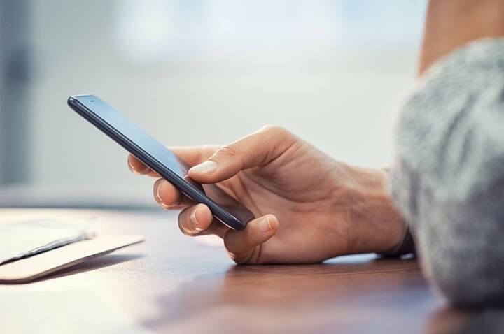 person looking a consumer base on her mobile phone 