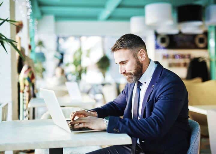man sitting looking at his laptop.