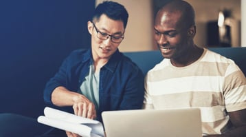 Asian and African American males talking and creating AMP email on computer