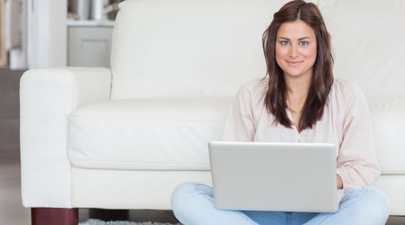 A young woman working on her laptop and learning more about the right email address format