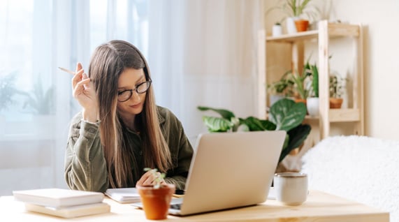 young caucasian woman working at computer desk designing a professional email signature