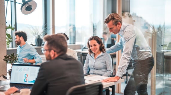 team working together with a cold email marketing agency in an office