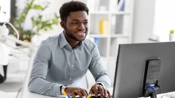 Tranquil young African-American man looks over the Ultimate Guide to Email Hygiene.