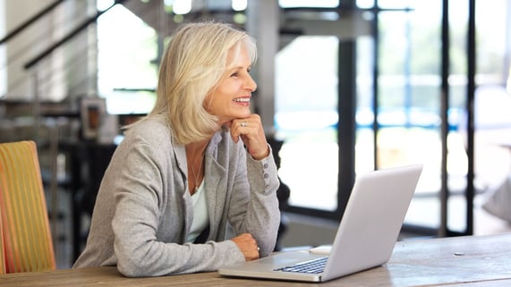 Senior citizen businesswoman updates her ecommerce website to ensure all of the must-have features are included.