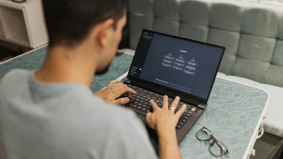 Man faces laptop with AI and LLM used to validate email addresses.