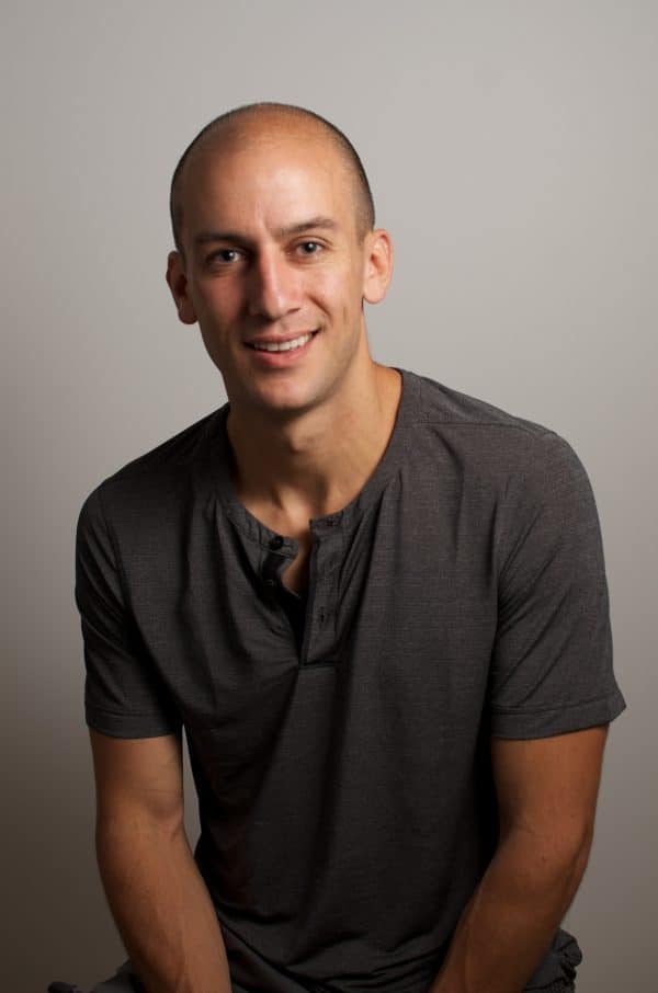 Author and speaker Ari Meisel wearing a gray shirt, featured in ZeroBounce interview on email productivity and inbox zero