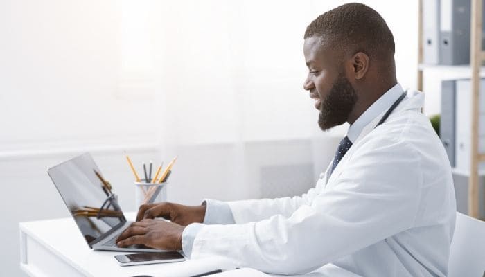 man sitting at his desk cleaning email list with ZeroBounce