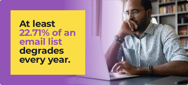 man with glasses in front of computer wearing short-sleeved shirt checking average email list decay report from zerobounce