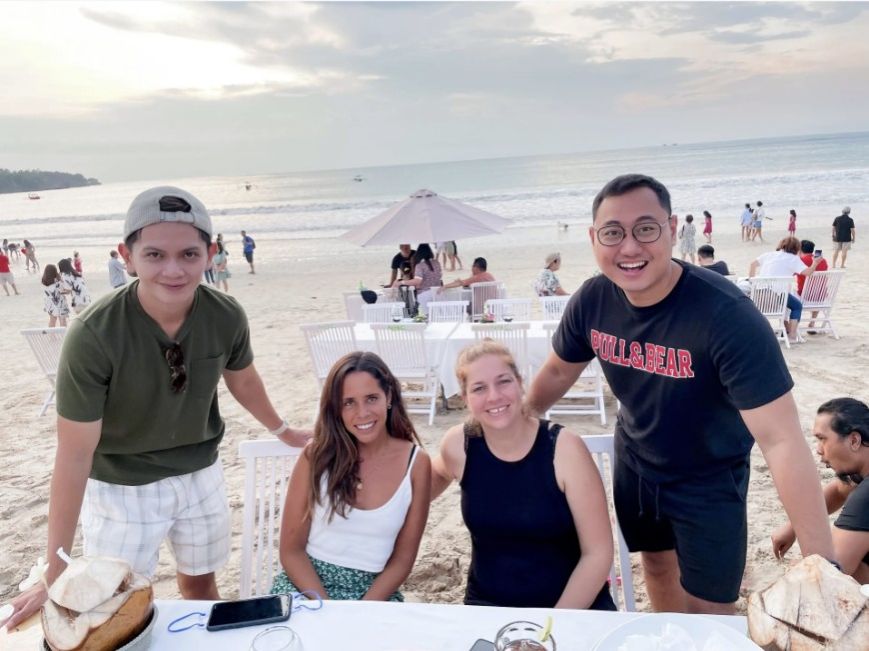 mailbird team having dinner in bali with ocean background talking about email tactics that boost revenue