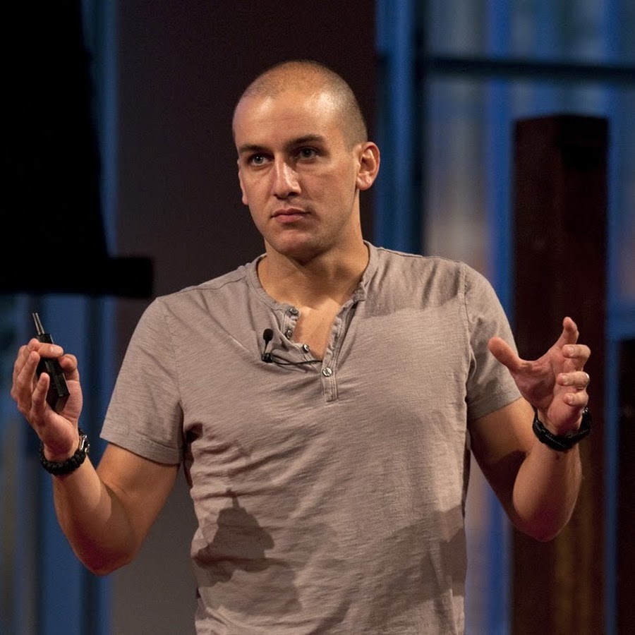 Ari Meisel on stage giving a TedX Talk.